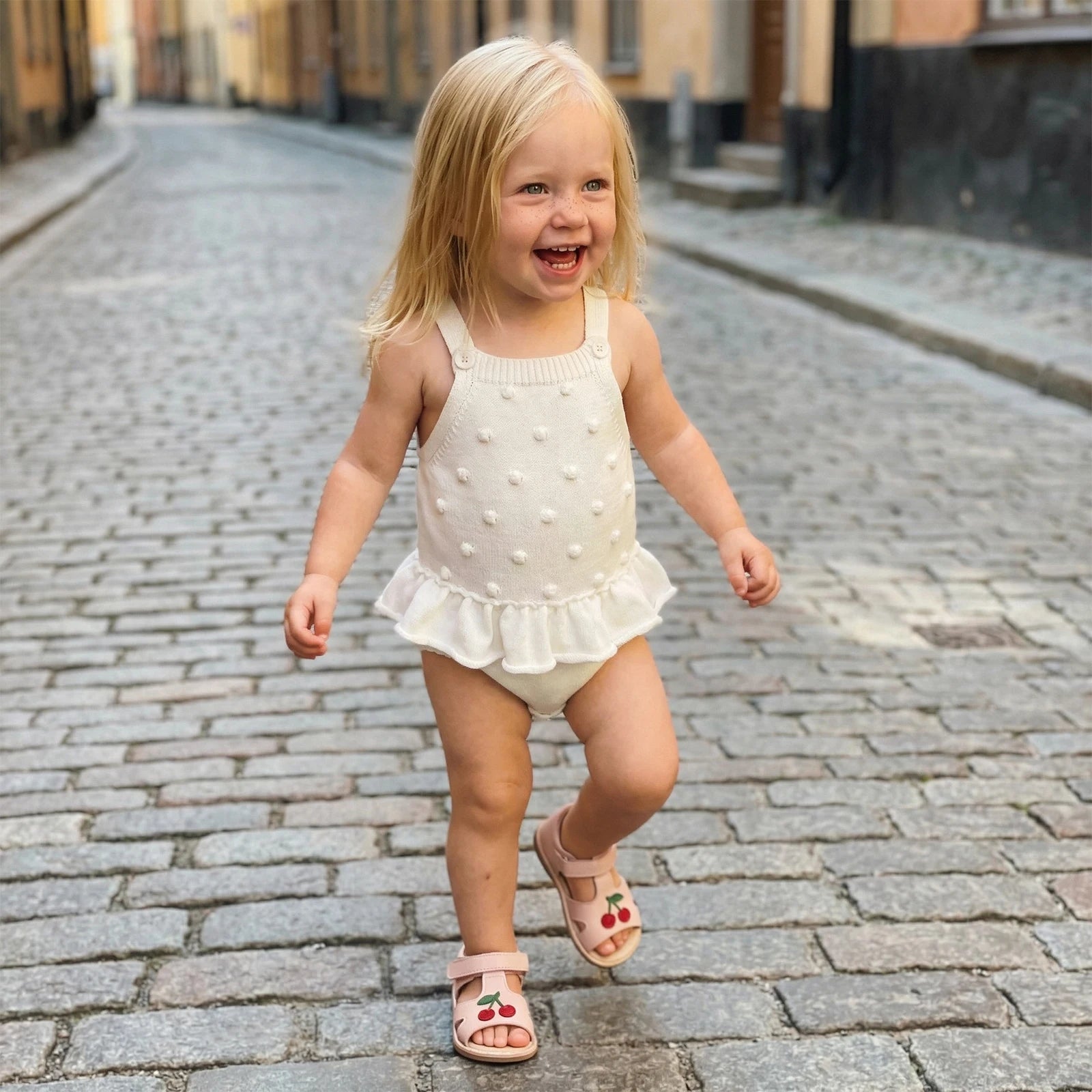 White Knit Pom Pom Romper With Ruffle Hem